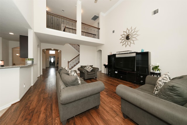 3314 Tall Sycamore Trl, Katy, TX 77493 - living area featuring arched walkways, stairway, wood finished floors, baseboards, and a high ceiling
