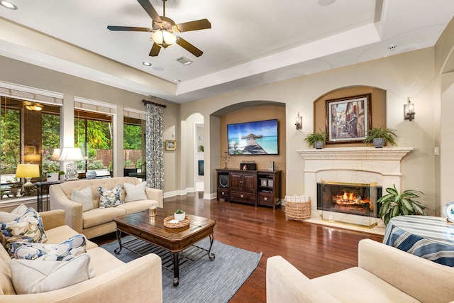 212 Salmon Creek Ln, Friendswood, TX 77546 - living area featuring a tray ceiling, wood finished floors, ceiling fan, a fireplace, and recessed lighting