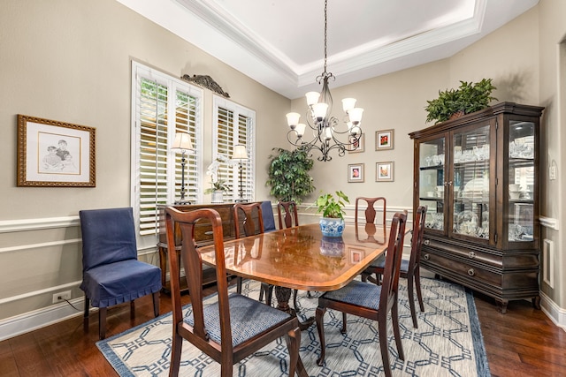 212 Salmon Creek Ln, Friendswood, TX 77546 - dining room featuring dark wood-type flooring, a chandelier, a tray ceiling, and ornamental molding