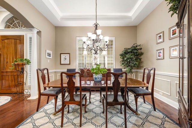 212 Salmon Creek Ln, Friendswood, TX 77546 - dining space with wood finished floors, a chandelier, and a tray ceiling