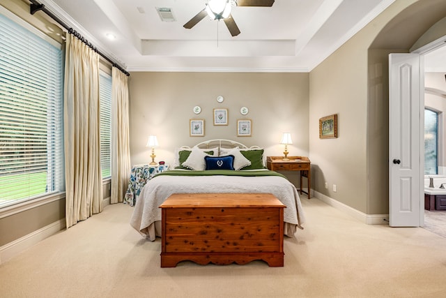 212 Salmon Creek Ln, Friendswood, TX 77546 - carpeted bedroom featuring a tray ceiling, baseboards, ceiling fan, and arched walkways