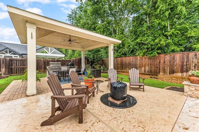 212 Salmon Creek Ln, Friendswood, TX 77546 - fenced backyard with a ceiling fan, a patio, area for grilling, and a gazebo