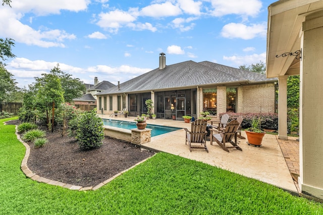 212 Salmon Creek Ln, Friendswood, TX 77546 - back of house with a sunroom, a patio area, roof with shingles, an outdoor pool, and a chimney