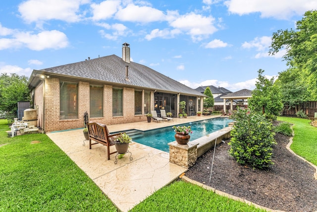 212 Salmon Creek Ln, Friendswood, TX 77546 - back of property with a gazebo, brick siding, a patio area, a chimney, and roof with shingles