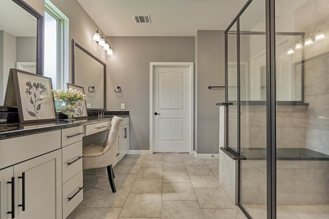 109 Pepper Grass Pl, Montgomery, TX 77316 - bathroom featuring vanity, a stall shower, baseboards, and tile patterned flooring