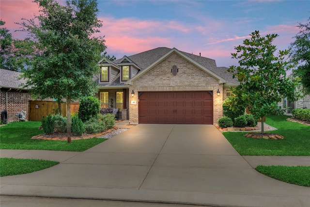 109 Pepper Grass Pl, Montgomery, TX 77316 - view of front of property featuring a garage, driveway, brick siding, and a lawn