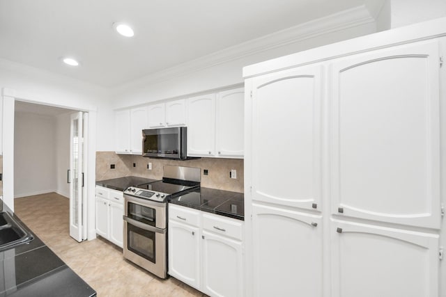 405 N Post Oak Ln Unit 405, Houston, TX 77024 - kitchen featuring appliances with stainless steel finishes, white cabinetry, ornamental molding, backsplash, and recessed lighting