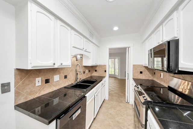 405 N Post Oak Ln Unit 405, Houston, TX 77024 - kitchen with stainless steel appliances, a sink, dark countertops, white cabinetry, and backsplash