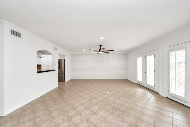 405 N Post Oak Ln Unit 405, Houston, TX 77024 - unfurnished living room with brick wall, crown molding, ceiling fan, recessed lighting, and baseboards