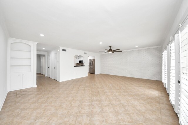 405 N Post Oak Ln Unit 405, Houston, TX 77024 - unfurnished living room with brick wall, a ceiling fan, recessed lighting, and light tile patterned floors