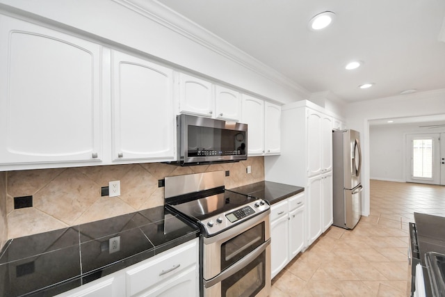 405 N Post Oak Ln Unit 405, Houston, TX 77024 - kitchen with stainless steel appliances, white cabinetry, light tile patterned flooring, crown molding, and recessed lighting
