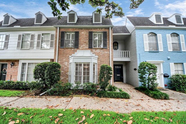 405 N Post Oak Ln Unit 405, Houston, TX 77024 - multi unit property with brick siding, a balcony, and roof with shingles