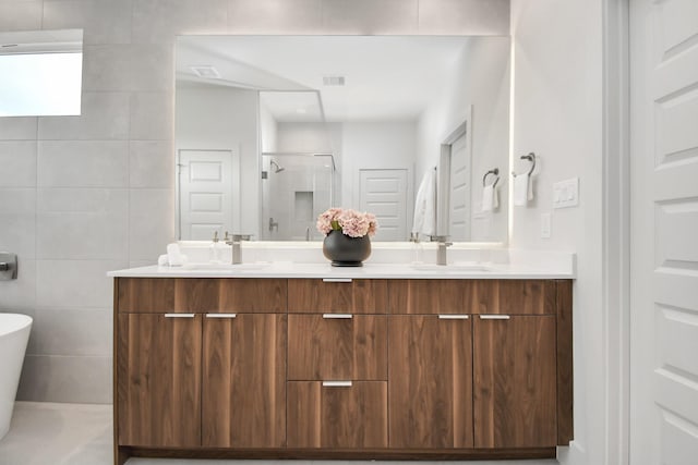 4020 Boho Ln, Houston, TX 77045 - bathroom with double vanity, a shower stall, and a freestanding bath