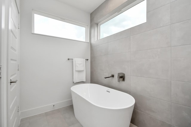 4020 Boho Ln, Houston, TX 77045 - bathroom featuring a freestanding bath and baseboards