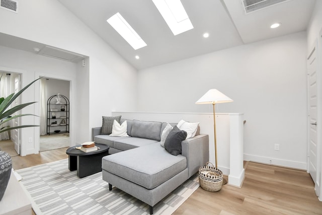 4020 Boho Ln, Houston, TX 77045 - living area featuring vaulted ceiling, light wood-type flooring, a skylight, and recessed lighting
