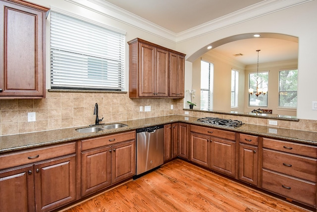 321 W 26th St Unit A, Houston, TX 77008 - kitchen featuring stainless steel dishwasher, a sink, gas cooktop, brown cabinetry, and crown molding