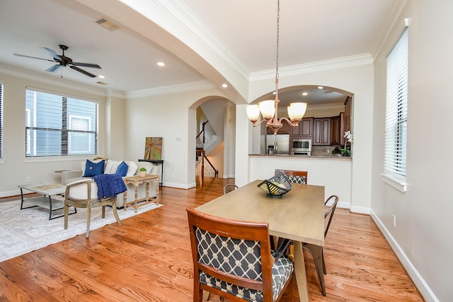 321 W 26th St Unit A, Houston, TX 77008 - dining room with arched walkways, light wood-style floors, a chandelier, baseboards, and a ceiling fan