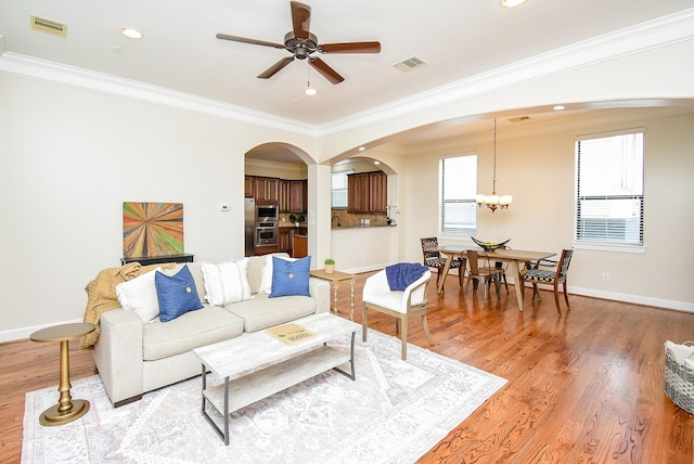 321 W 26th St Unit A, Houston, TX 77008 - living area with arched walkways, light wood finished floors, crown molding, a ceiling fan, and baseboards