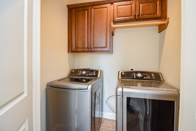 321 W 26th St Unit A, Houston, TX 77008 - washroom featuring washing machine and dryer, cabinet space, baseboards, and tile patterned floors