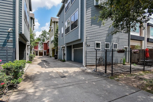 321 W 26th St Unit A, Houston, TX 77008 - view of home's exterior with an attached garage, driveway, and a residential view