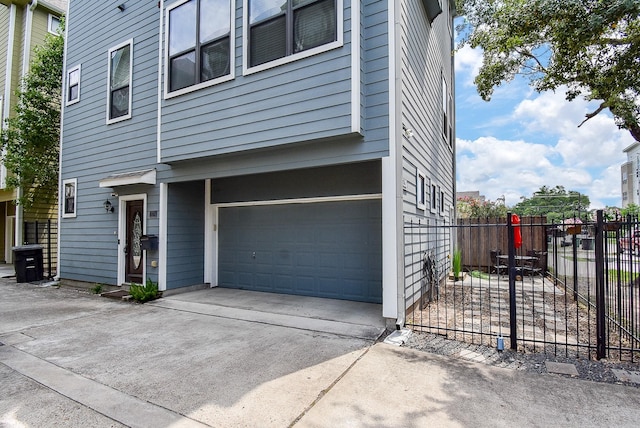 321 W 26th St Unit A, Houston, TX 77008 - view of home's exterior featuring an attached garage and driveway