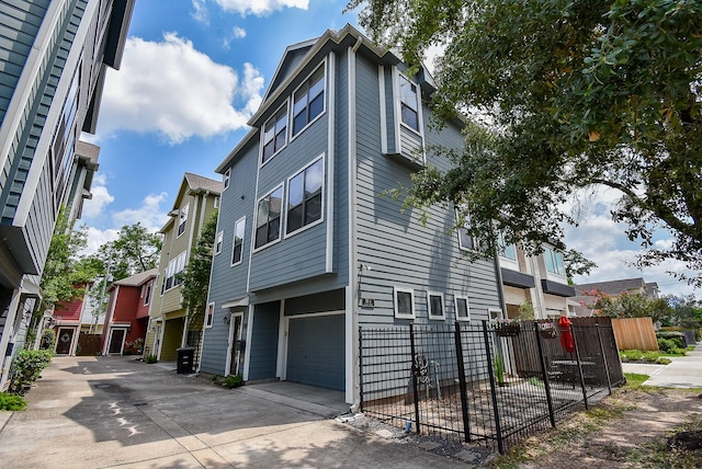 321 W 26th St Unit A, Houston, TX 77008 - view of home's exterior featuring an attached garage and driveway
