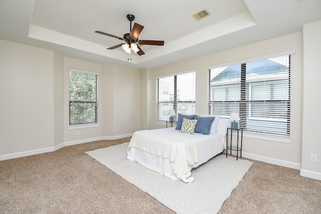 321 W 26th St Unit A, Houston, TX 77008 - bedroom with a raised ceiling, light carpet, baseboards, and a ceiling fan