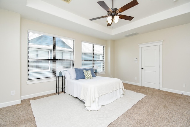 321 W 26th St Unit A, Houston, TX 77008 - bedroom with a tray ceiling, light colored carpet, baseboards, and ceiling fan
