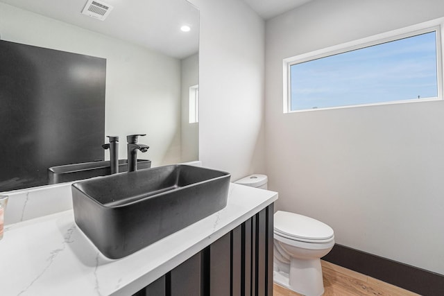 1116 Peden St, Houston, TX 77006 - bathroom featuring toilet, wood finished floors, and vanity