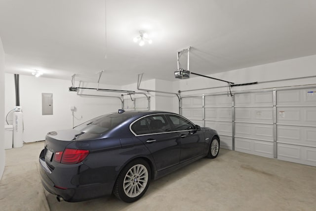 7919 Chantilly Mnr, Fulshear, TX 77441 - garage featuring electric panel and a garage door opener