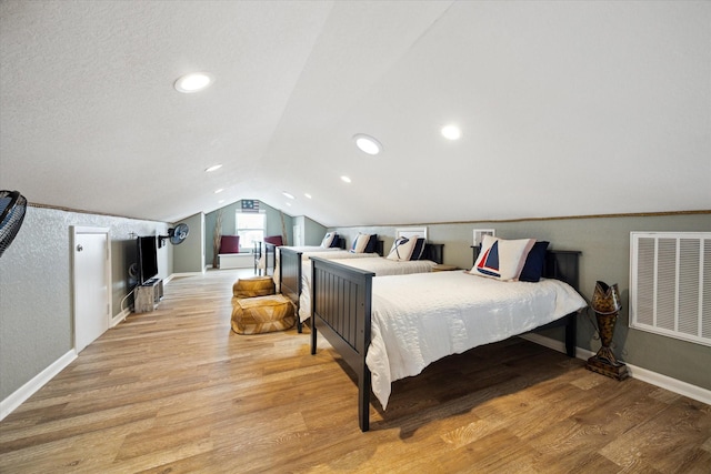 219 Bora Bora Dr, Tiki Island, TX 77554 - bedroom with lofted ceiling, baseboards, and light wood-style floors