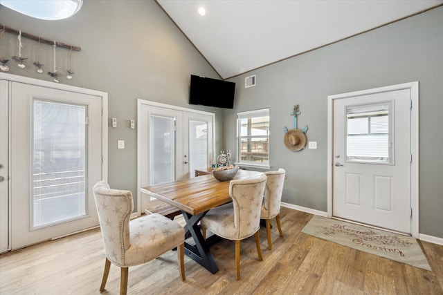 219 Bora Bora Dr, Tiki Island, TX 77554 - dining area featuring french doors, light wood-style flooring, high vaulted ceiling, and baseboards
