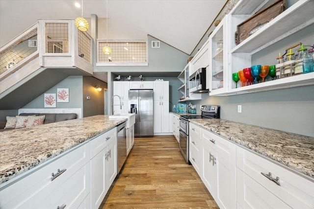 219 Bora Bora Dr, Tiki Island, TX 77554 - kitchen with stainless steel appliances, open shelves, high vaulted ceiling, white cabinets, and glass insert cabinets