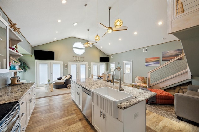219 Bora Bora Dr, Tiki Island, TX 77554 - kitchen with open floor plan, a sink, stainless steel appliances, french doors, and high vaulted ceiling