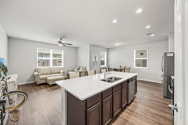 3919 Faletti Dr, Katy, TX 77493 - kitchen featuring a sink, appliances with stainless steel finishes, dark brown cabinetry, a ceiling fan, and an island with sink