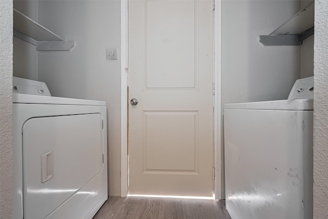 8621 Rustling Lvs Dr, Houston, TX 77083 - laundry area with washing machine and dryer and wood finished floors