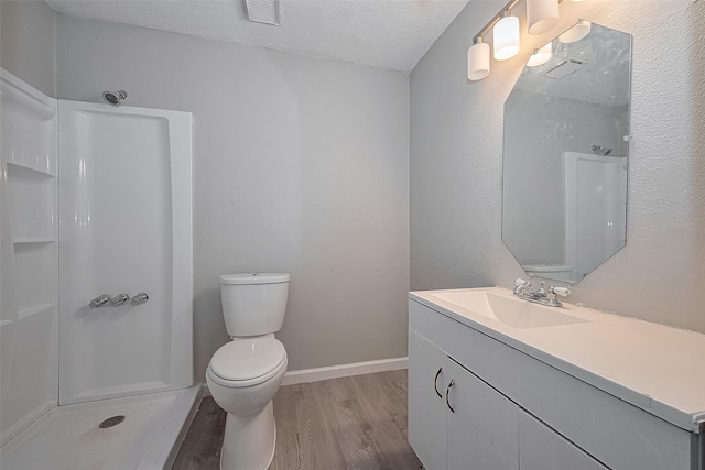 8621 Rustling Lvs Dr, Houston, TX 77083 - bathroom with wood finished floors, vanity, a shower, toilet, and a textured ceiling