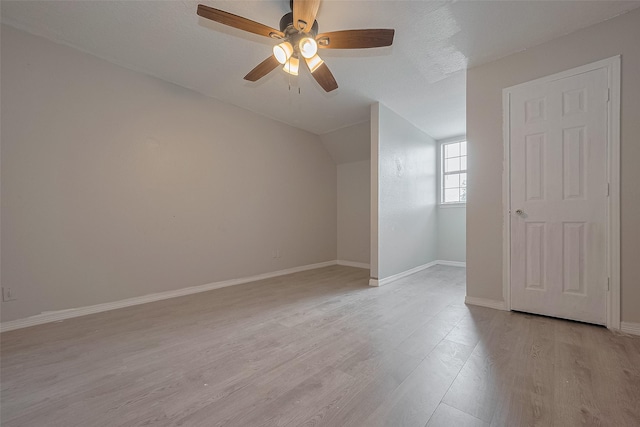 8621 Rustling Lvs Dr, Houston, TX 77083 - additional living space featuring lofted ceiling, light wood-style floors, a ceiling fan, and baseboards