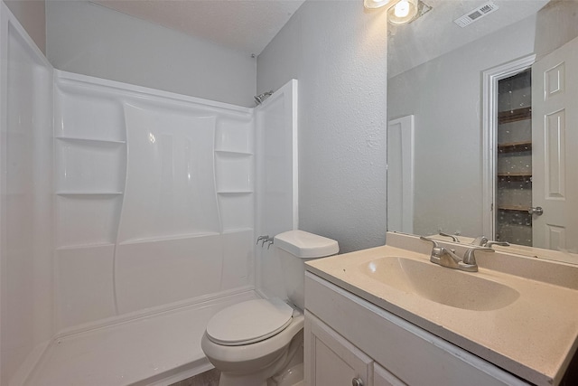 8621 Rustling Lvs Dr, Houston, TX 77083 - bathroom with a shower, vanity, toilet, and a textured wall