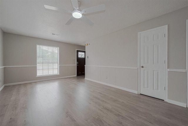 8621 Rustling Lvs Dr, Houston, TX 77083 - spare room featuring wood finished floors, a ceiling fan, and baseboards