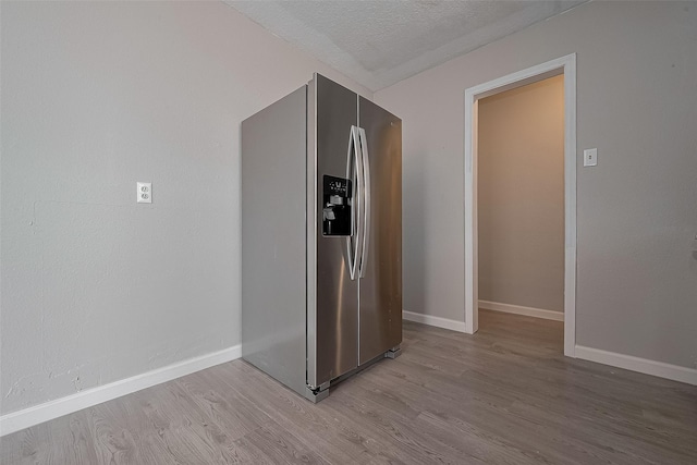8621 Rustling Lvs Dr, Houston, TX 77083 - hall featuring wood finished floors, baseboards, and a textured ceiling