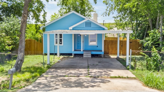 8402 Bassett St, Houston, TX 77051 - view of front of house featuring covered porch, driveway, and a chimney