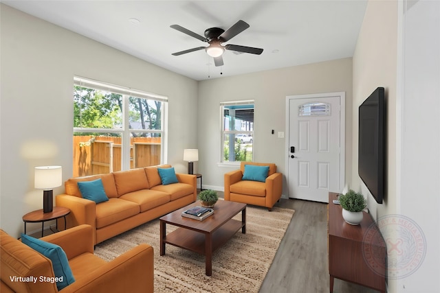 8402 Bassett St, Houston, TX 77051 - living room with light wood-style floors, a ceiling fan, and baseboards