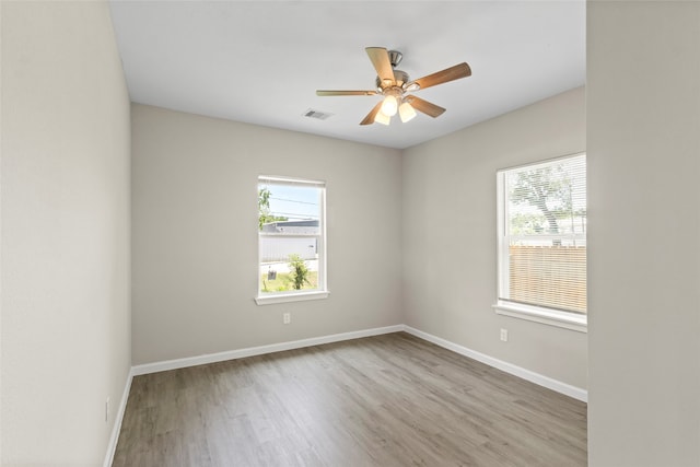 8402 Bassett St, Houston, TX 77051 - spare room featuring healthy amount of natural light, wood finished floors, ceiling fan, and baseboards