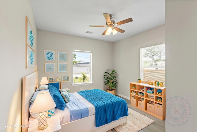 8402 Bassett St, Houston, TX 77051 - bedroom featuring multiple windows, wood finished floors, ceiling fan, and baseboards