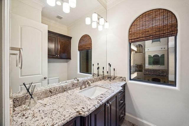 1604 Fowler St, Houston, TX 77007 - bathroom with vanity, crown molding, baseboards, and toilet
