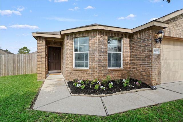 9822 Garnet Springs Dr, Iowa Colony, TX 77583 - property entrance with a garage and brick siding