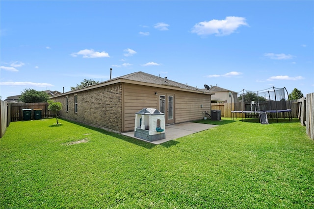 9822 Garnet Springs Dr, Iowa Colony, TX 77583 - back of house with a trampoline, a patio, central AC unit, brick siding, and french doors