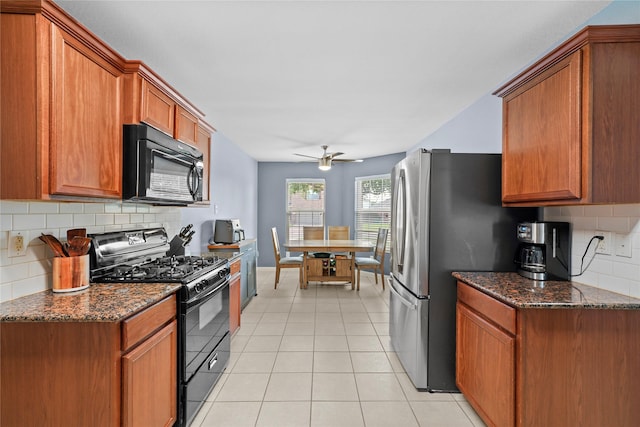 9822 Garnet Springs Dr, Iowa Colony, TX 77583 - kitchen with black appliances, a ceiling fan, tasteful backsplash, brown cabinetry, and dark stone counters