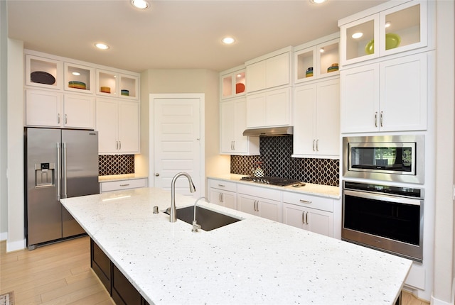 22911 Pearl Glen Dr, Richmond, TX 77469 - kitchen featuring stainless steel appliances, a sink, a kitchen island with sink, white cabinetry, and recessed lighting